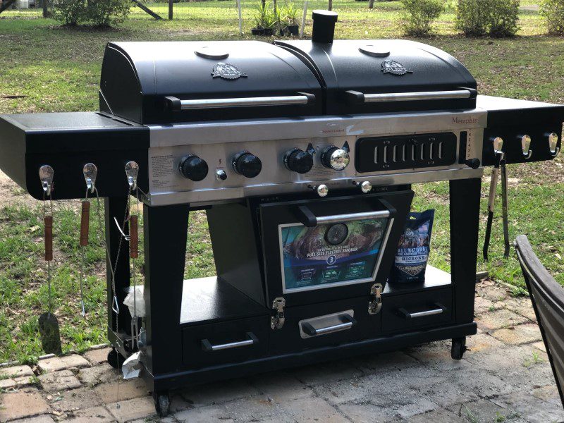 A grill with two ovens and a television on top.