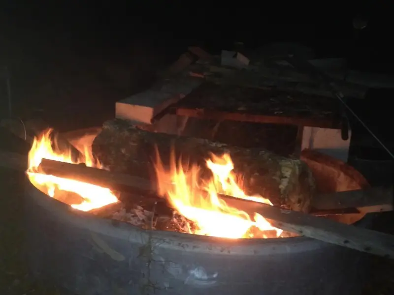 A fire is burning in the middle of an outdoor grill.