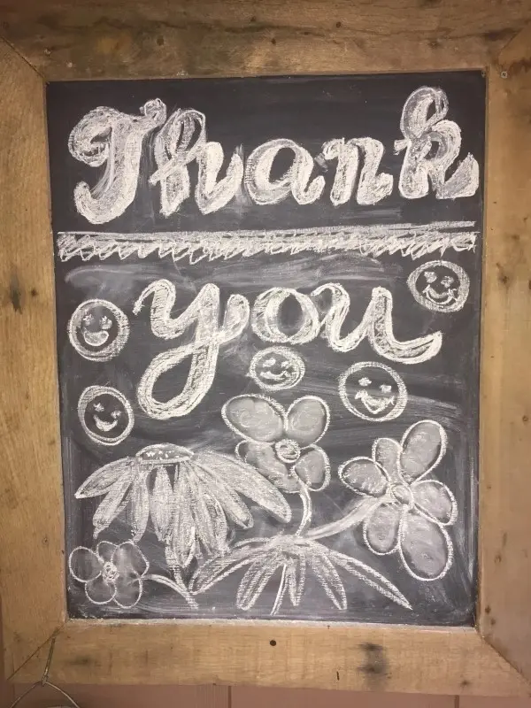 A chalkboard with the words " thank you ".