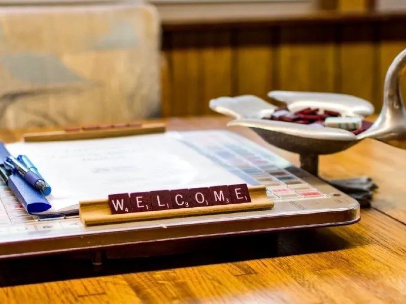 A wooden table with a sign that says " welcome ".