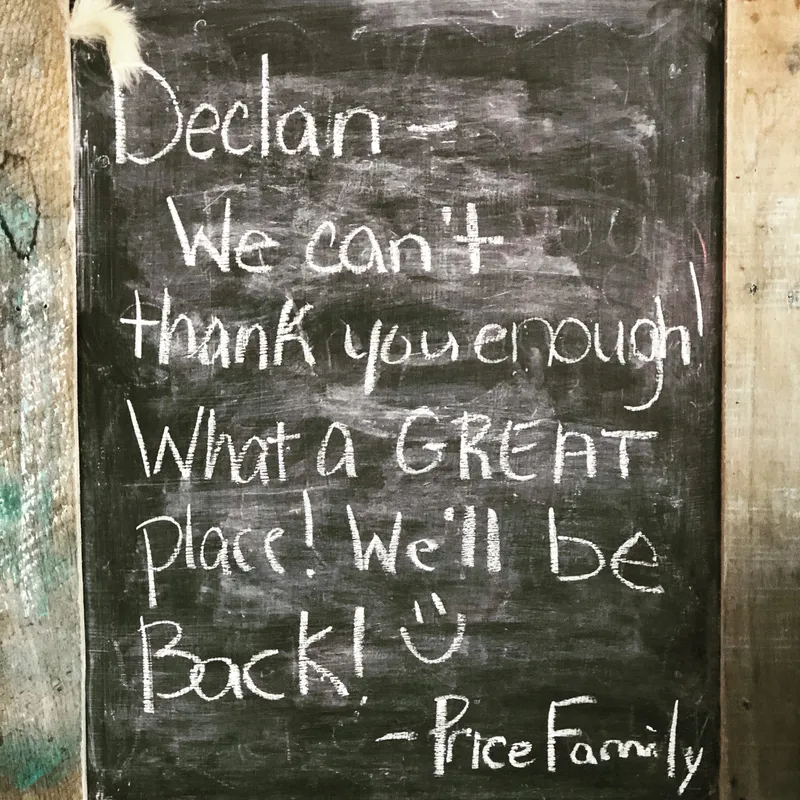 A chalkboard with the words " declan-we can 't thank you enough what a great place ! we 'll be back !" written on it
